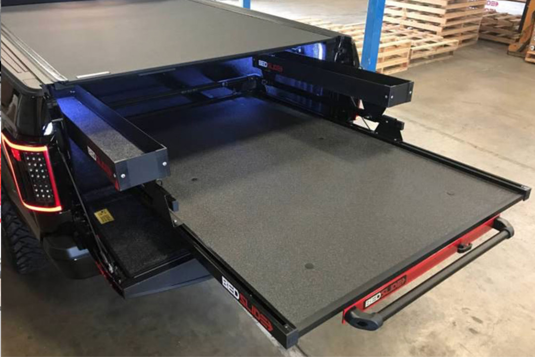 Heavy-duty sliding cargo tray extended out of pickup truck bed